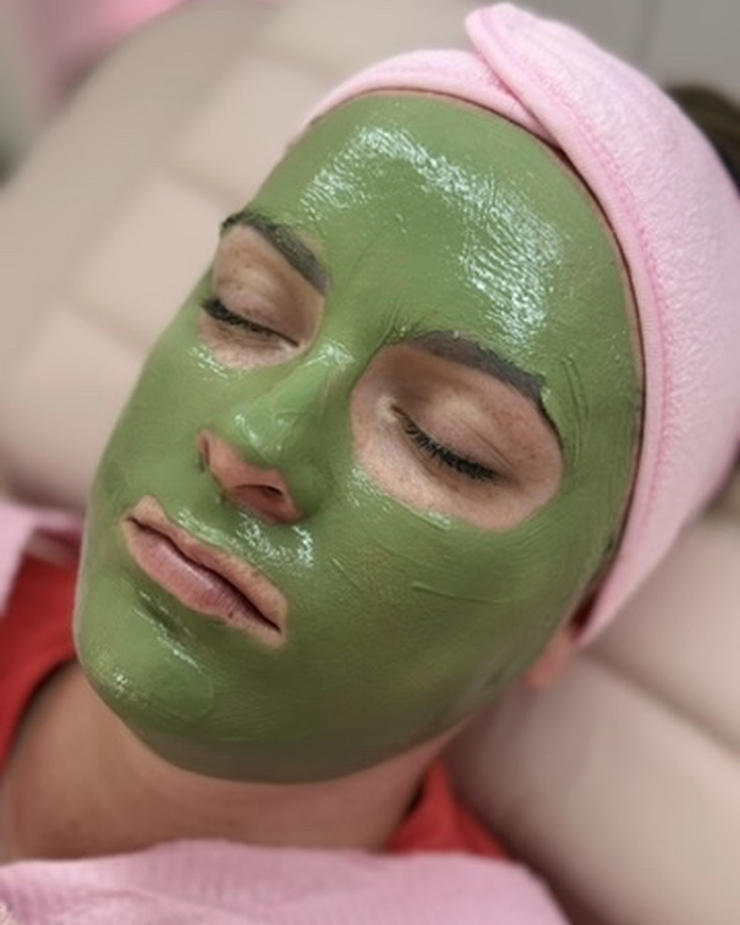 Client relaxing with a green clarifying mask during an Acne Facial at LA Skin Spa