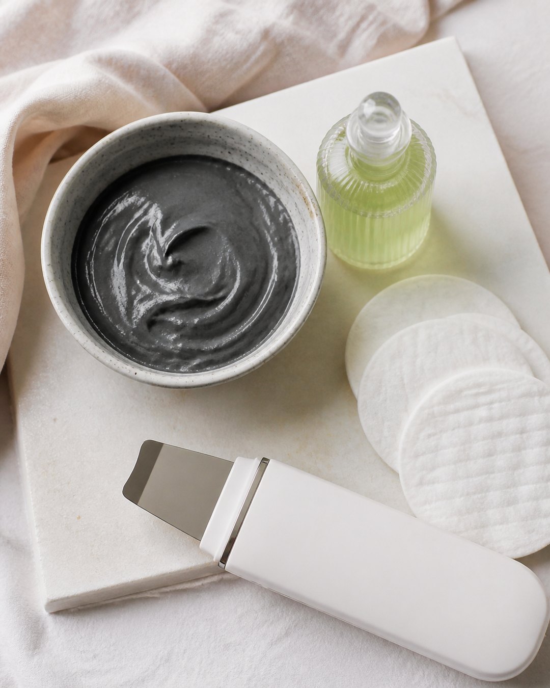 Charcoal mask, peel solution, cotton rounds and ultrasonic spatula