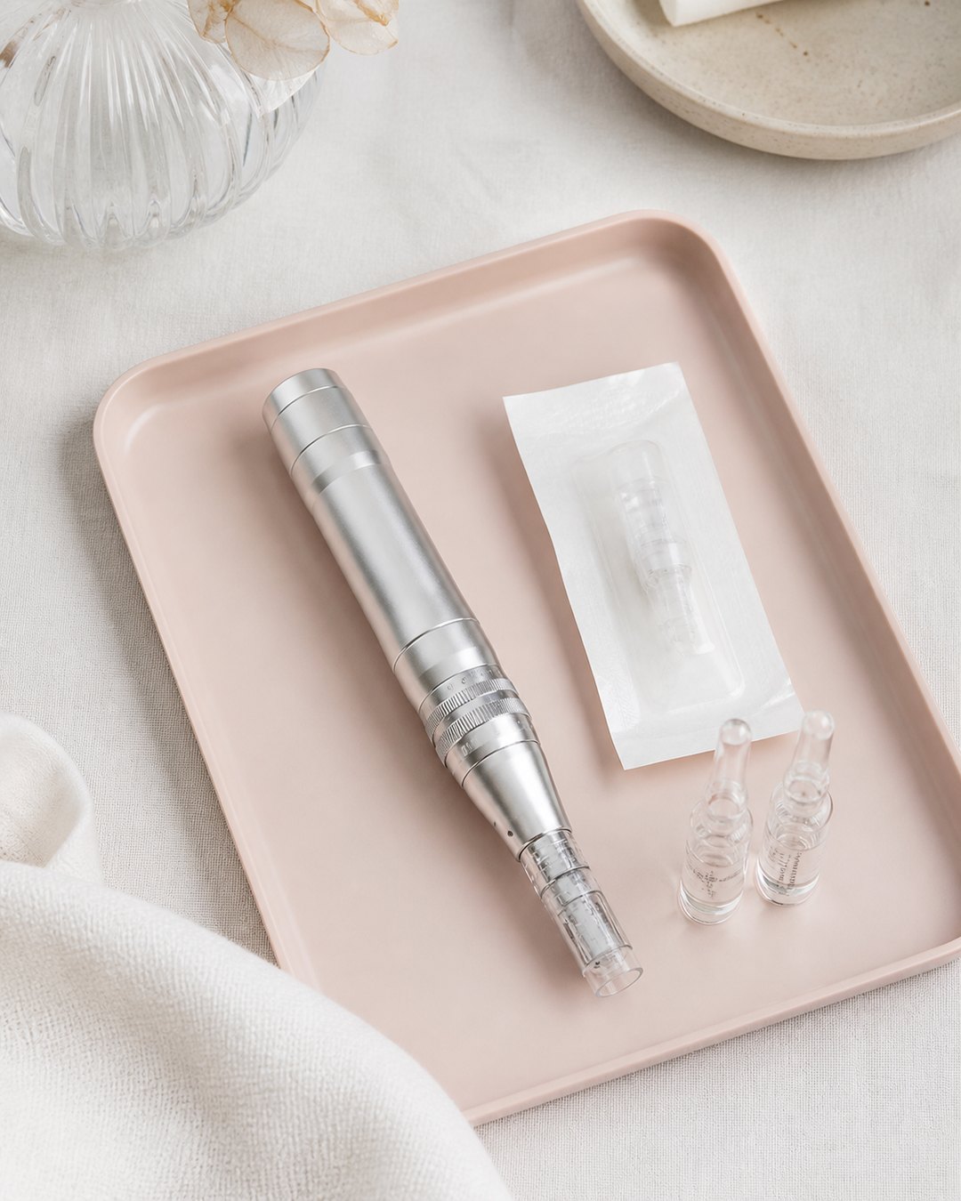 Microneedling pen and sealed cartridge arranged on a blush treatment tray
